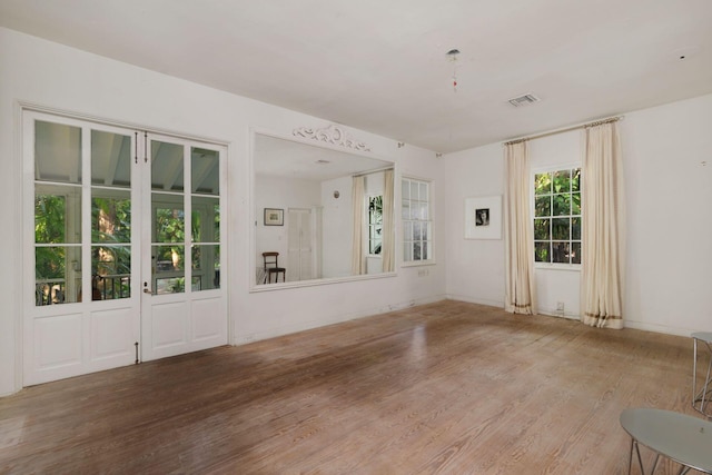 unfurnished room featuring wood finished floors and visible vents