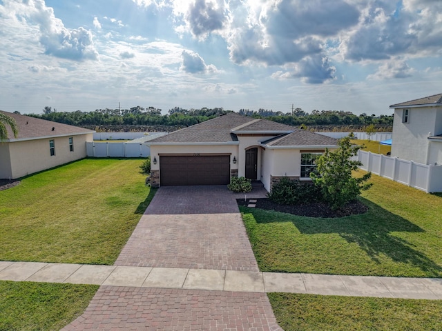 view of front of property with a garage and a front yard