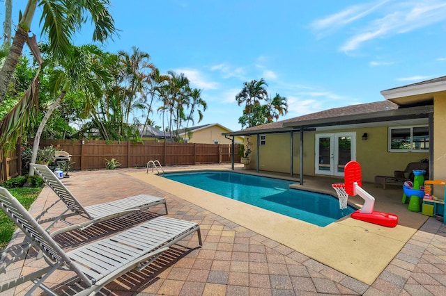 view of pool with a patio area and french doors