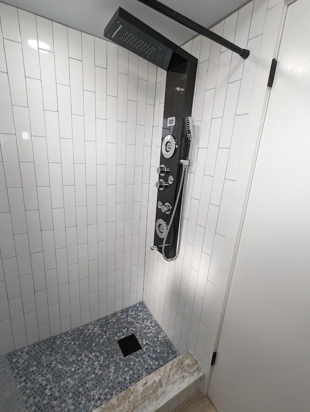 bathroom with a tile shower