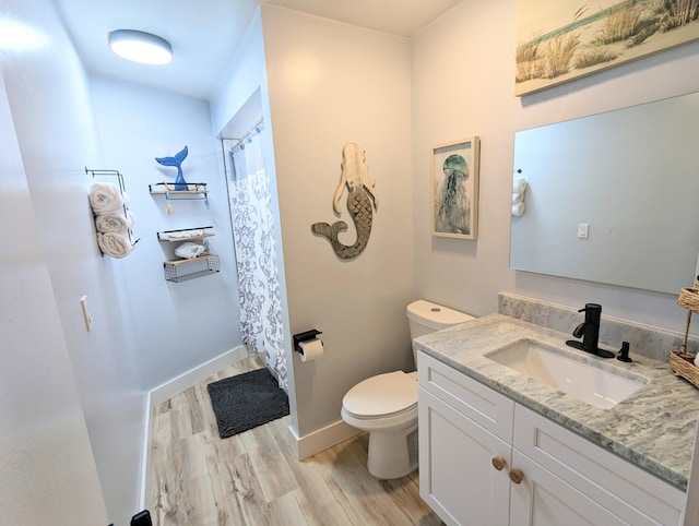 bathroom featuring a shower with curtain, vanity, toilet, and hardwood / wood-style floors