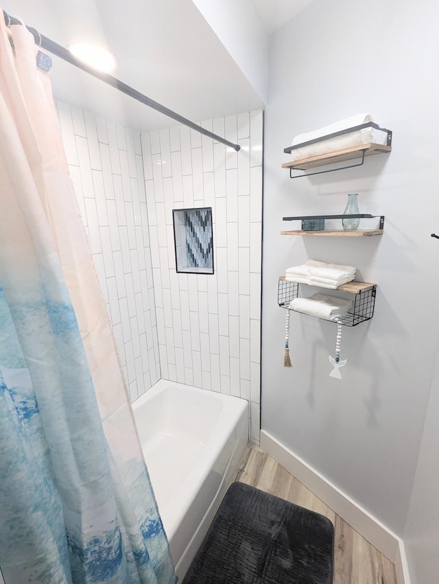 bathroom featuring shower / bathtub combination with curtain and hardwood / wood-style floors