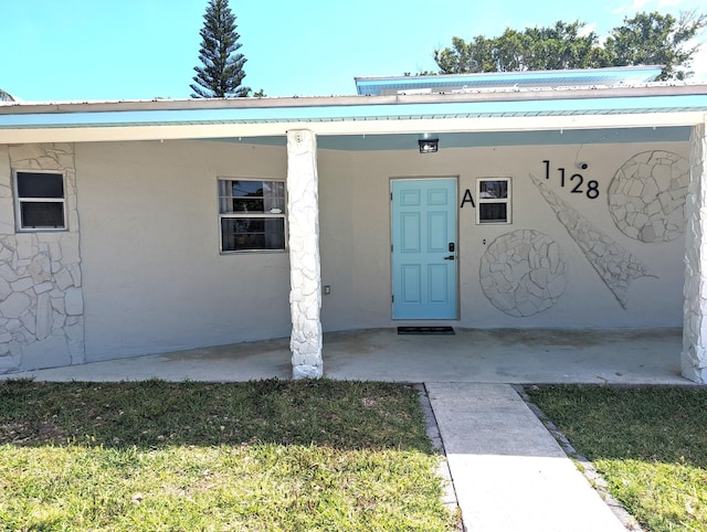 property entrance with a yard