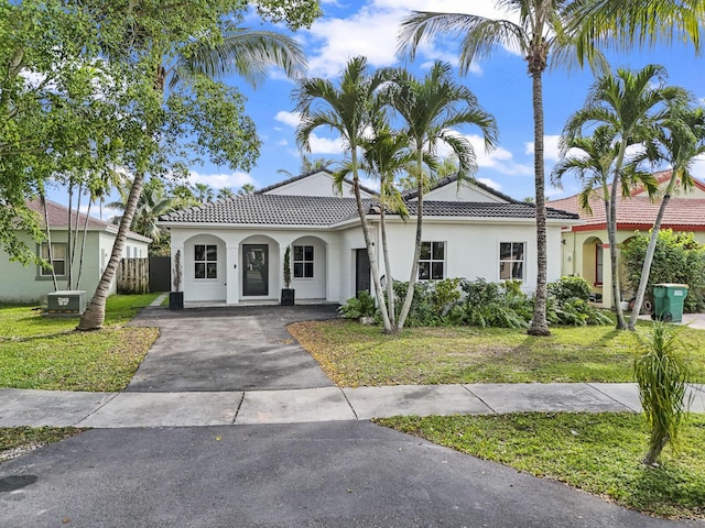 mediterranean / spanish house with a front yard