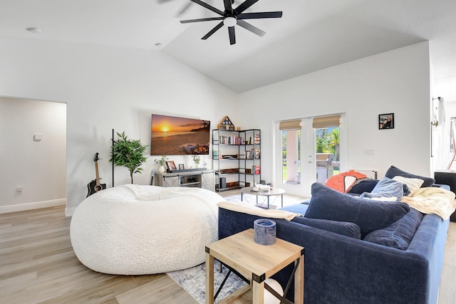 living room featuring french doors, ceiling fan, high vaulted ceiling, and light wood-type flooring