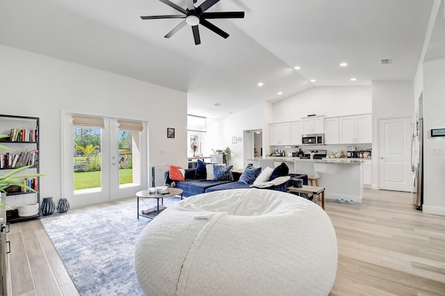 living room featuring french doors, ceiling fan, high vaulted ceiling, and light wood-type flooring