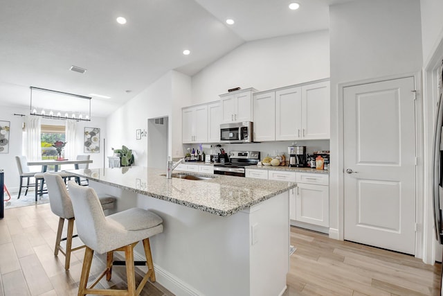 kitchen featuring white cabinetry, sink, an island with sink, and appliances with stainless steel finishes