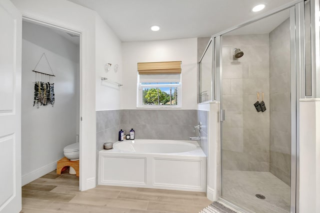 bathroom featuring toilet and plus walk in shower