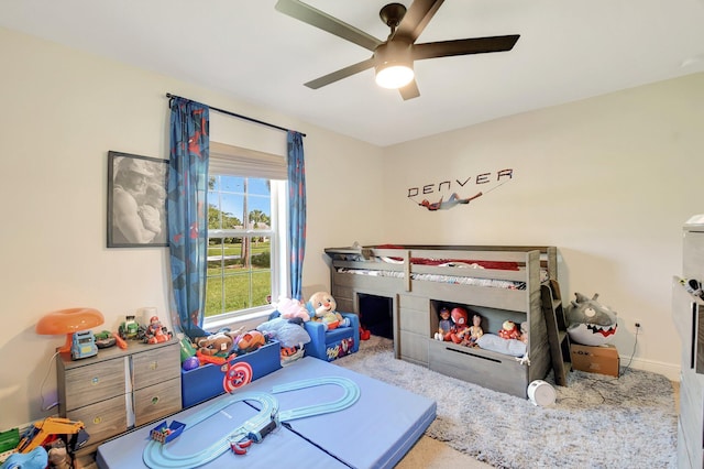 playroom featuring light carpet and ceiling fan