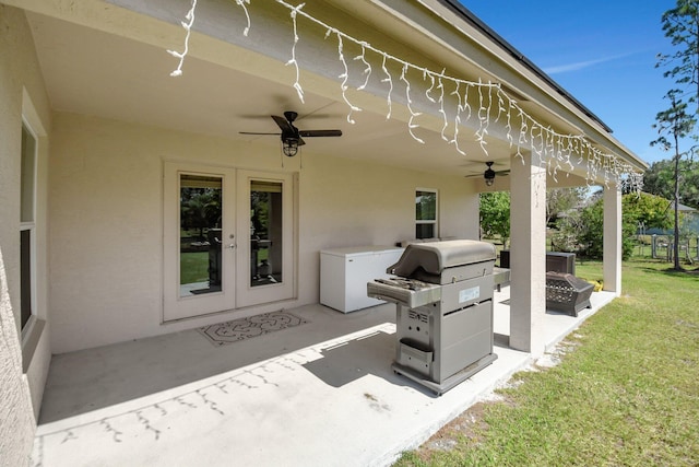 view of patio / terrace with french doors, ceiling fan, and an outdoor fire pit