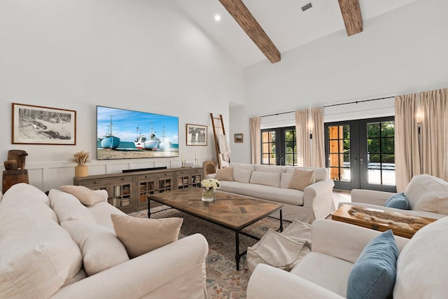 living room with beam ceiling, high vaulted ceiling, and french doors