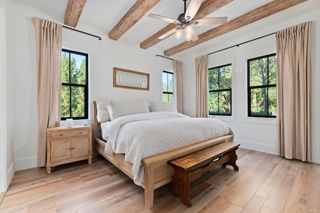 bedroom with multiple windows, beam ceiling, light hardwood / wood-style floors, and ceiling fan