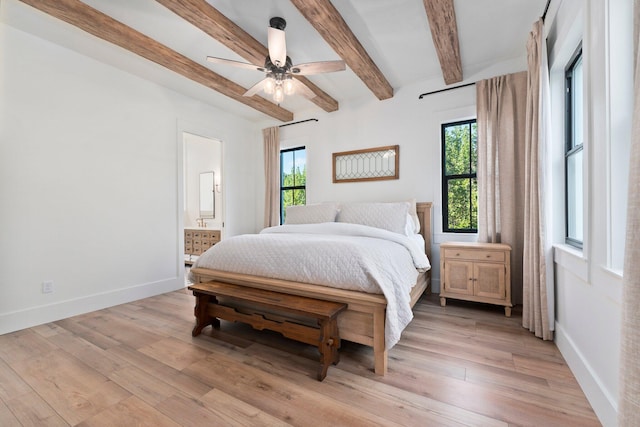 bedroom featuring ensuite bathroom, ceiling fan, beam ceiling, and light hardwood / wood-style flooring