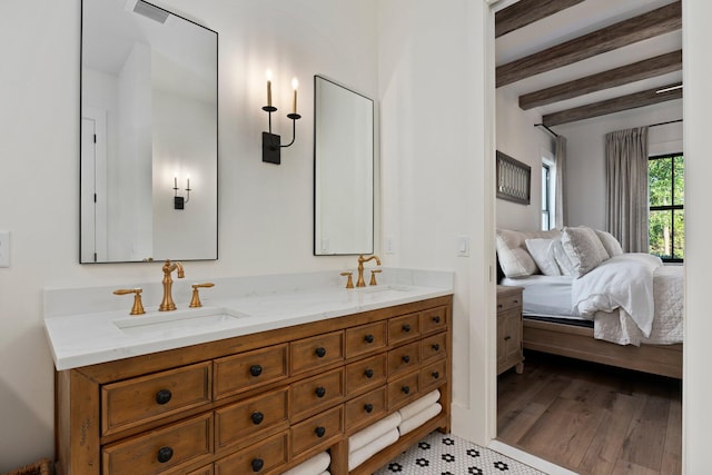 bathroom featuring beamed ceiling, vanity, and hardwood / wood-style floors