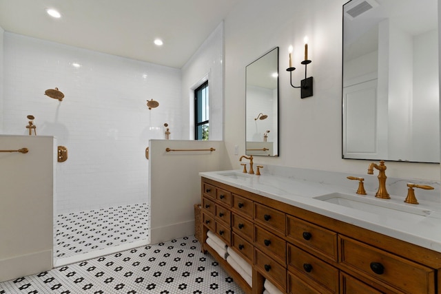 bathroom featuring vanity and tiled shower