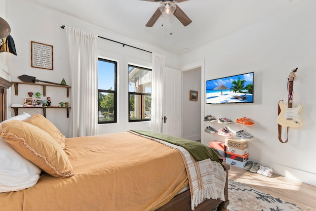 bedroom with hardwood / wood-style flooring and ceiling fan