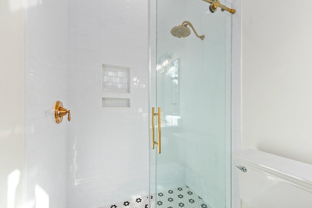 bathroom with a shower with door