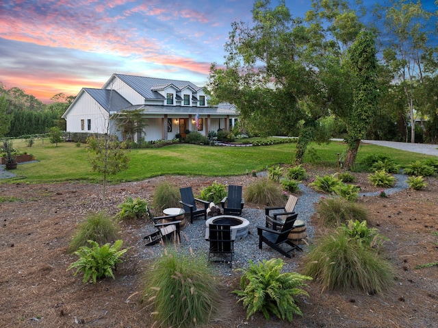 yard at dusk featuring a fire pit