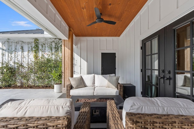 view of patio / terrace with an outdoor living space, ceiling fan, and french doors