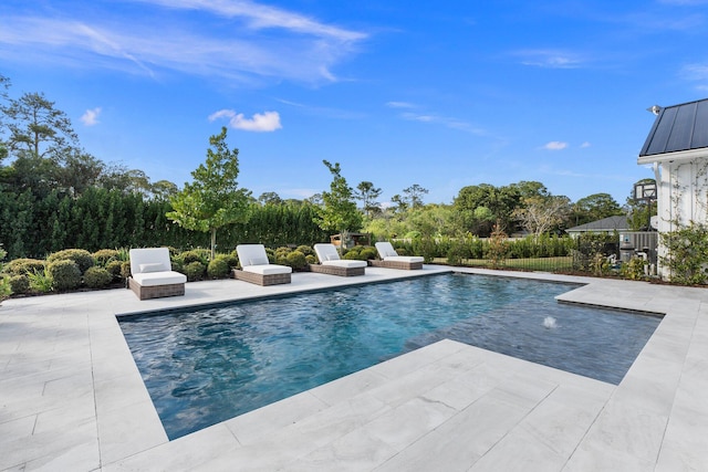 view of swimming pool featuring a patio area