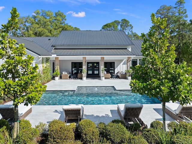 rear view of house with an outdoor hangout area, french doors, and a patio area