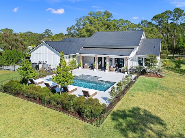 back of property with an outdoor hangout area, a yard, and a patio area