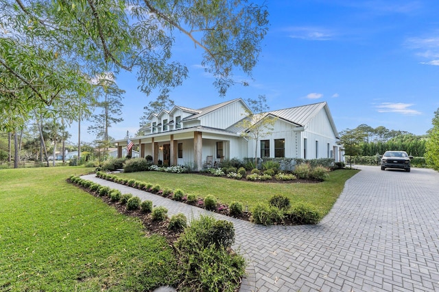 view of front of home with covered porch and a front yard