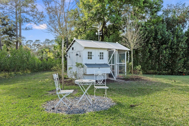 exterior space featuring an outbuilding and a lawn