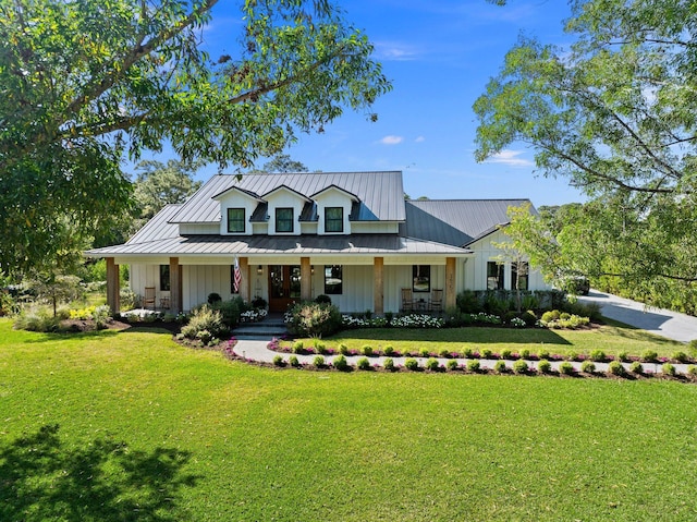 modern farmhouse style home with covered porch and a front lawn