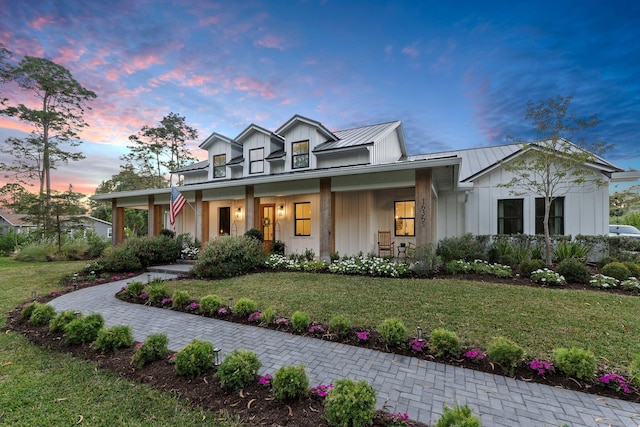 view of front of house with a yard and covered porch