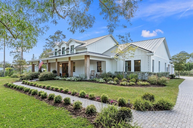 view of front of property with a porch and a front yard