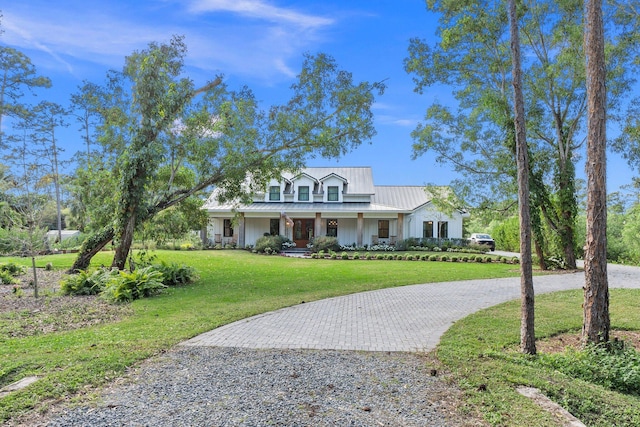 view of front of home with a porch and a front lawn