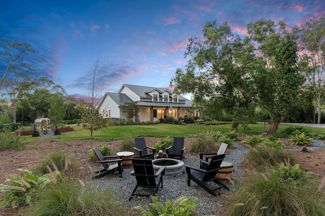 yard at dusk with a fire pit