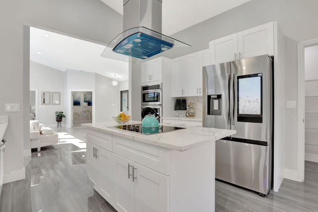 kitchen featuring light stone counters, a kitchen island, island exhaust hood, stainless steel appliances, and white cabinets