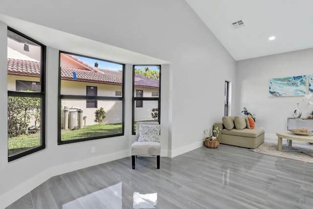 living area with high vaulted ceiling