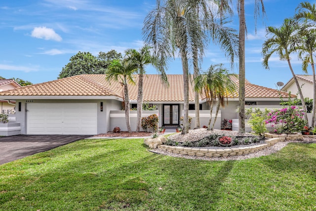 view of front of house featuring a garage and a front yard