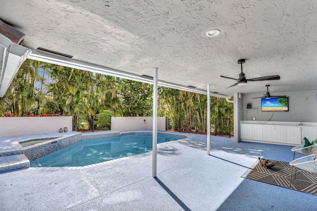 view of swimming pool featuring ceiling fan and a patio area