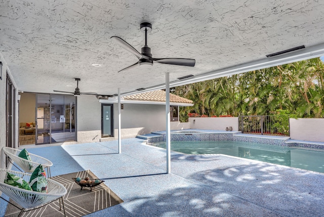 view of swimming pool featuring an in ground hot tub, ceiling fan, and a patio area