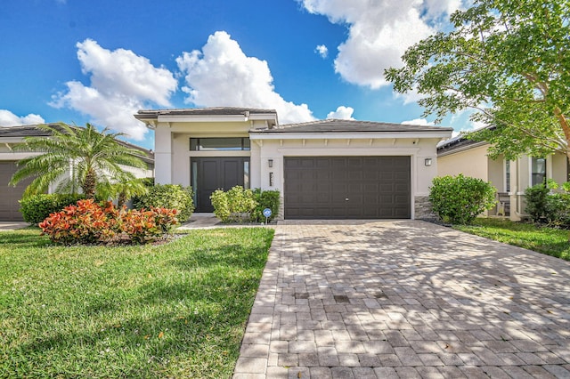 view of front of house featuring a garage and a front lawn