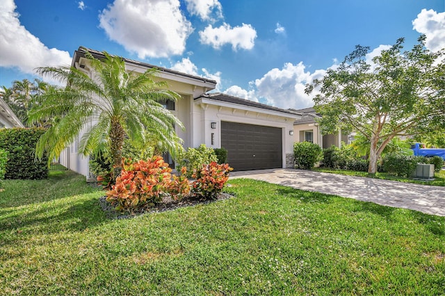 view of front of home with a front yard and a garage