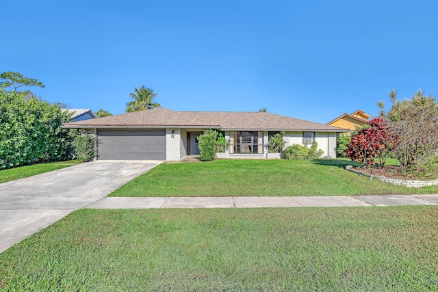 ranch-style house with a garage, a front yard, concrete driveway, and brick siding