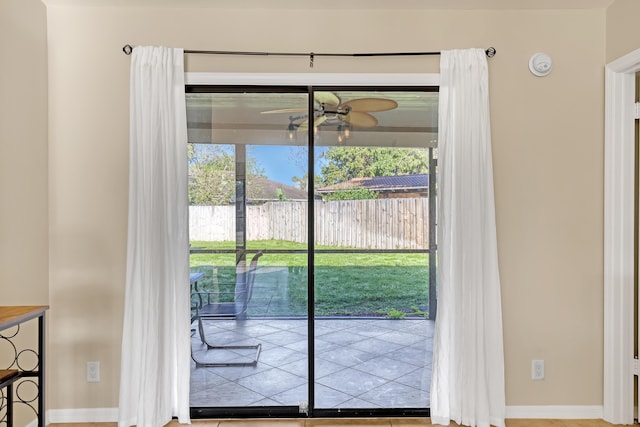 doorway to outside featuring a ceiling fan