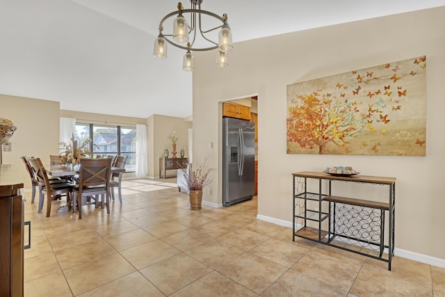 dining room featuring baseboards, high vaulted ceiling, light tile patterned floors, and a notable chandelier