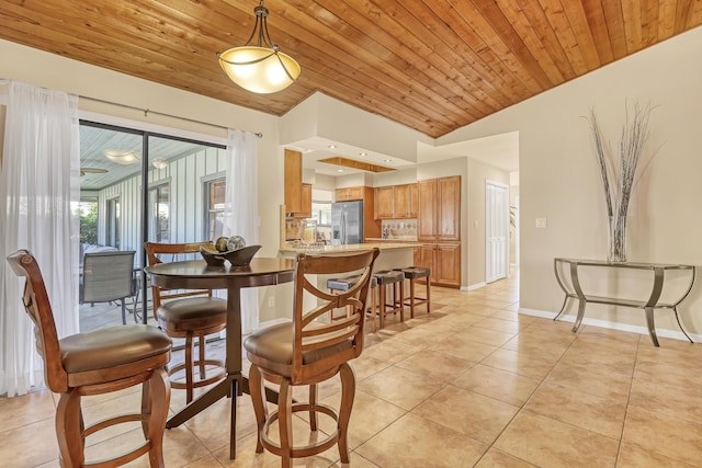 dining room featuring lofted ceiling, wood ceiling, baseboards, and light tile patterned floors