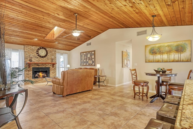 living area with lofted ceiling with skylight, wood ceiling, visible vents, and light tile patterned flooring