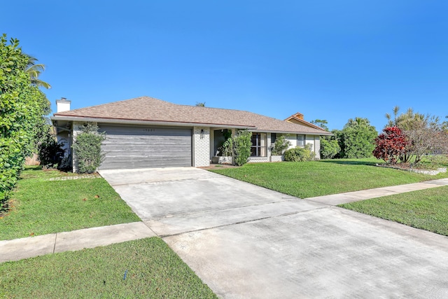 ranch-style house with a garage, brick siding, driveway, a front lawn, and a chimney