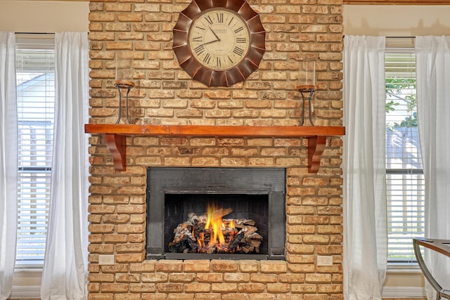 interior details featuring a brick fireplace