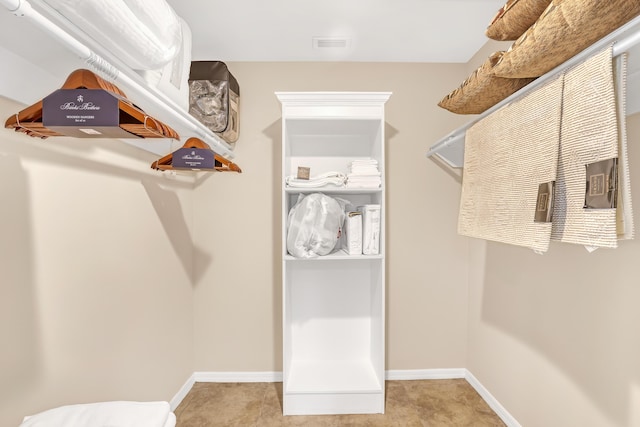 walk in closet featuring light tile patterned floors and visible vents