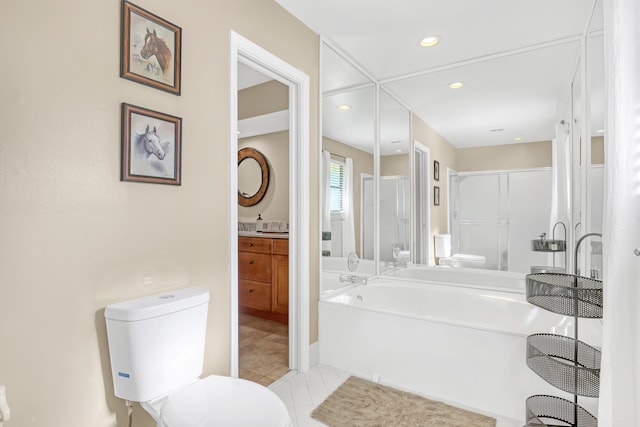 bathroom with toilet, tile patterned floors, vanity, a bath, and recessed lighting