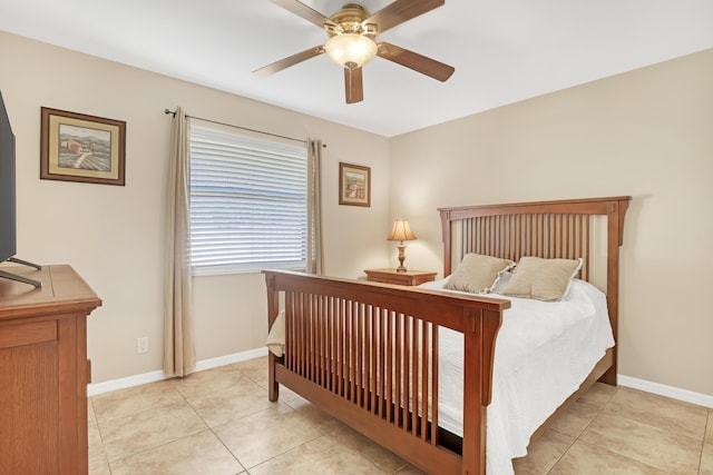 bedroom with light tile patterned flooring, a ceiling fan, and baseboards